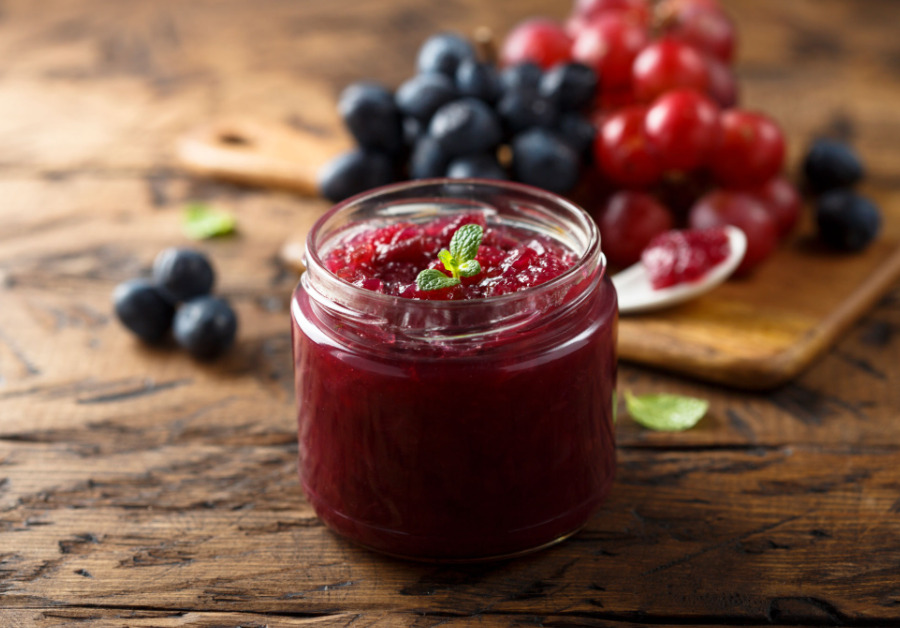 Geleia de frutas vermelhas orgânica em um pote, destacando a qualidade e os benefícios para a saúde.